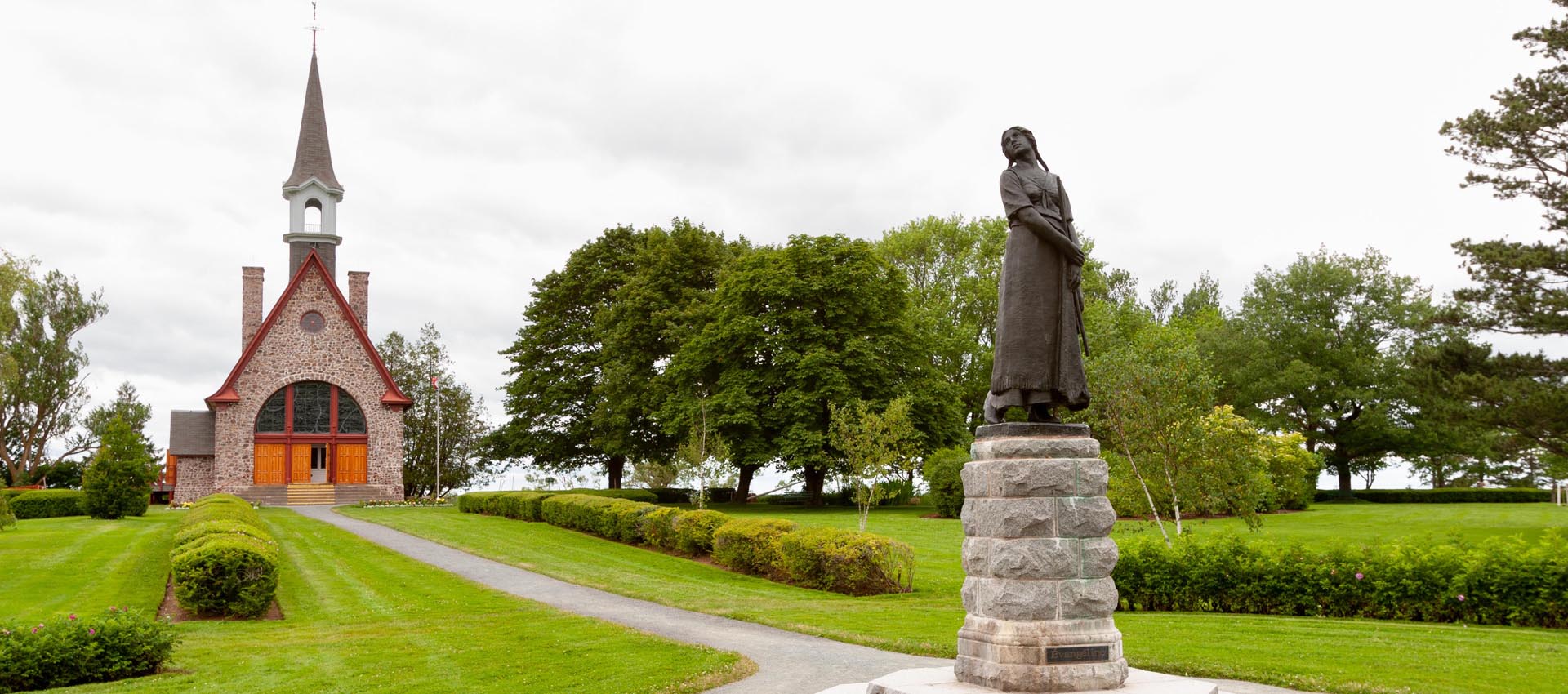 The statue of Evangeline and the church at Grand Pré National Historic Site, near Wolfville, Nova Scotia